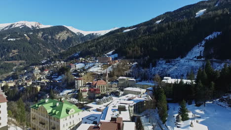 beautiful european mountain city with church in winter season, aerial view