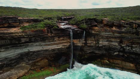 curracurrong falls, australia drone shot of waterfall and green foliage