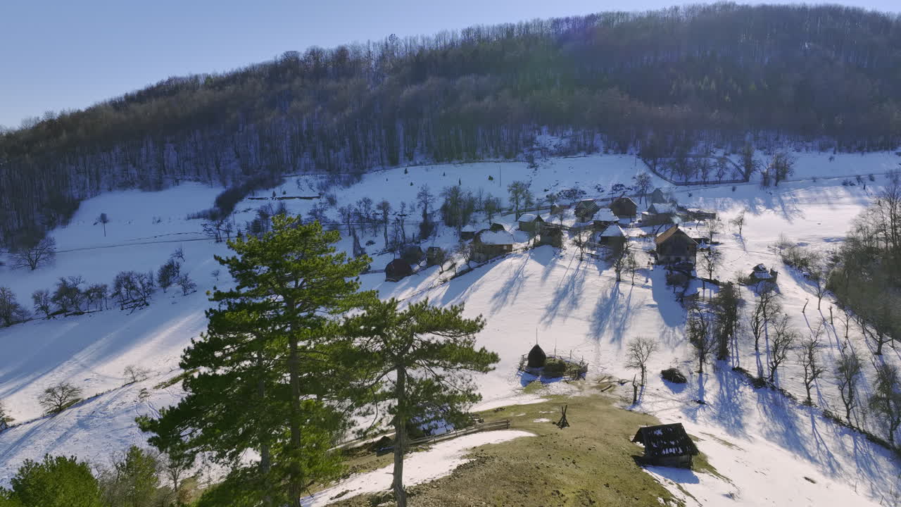 Traditional Village Nestled in a Snow-Covered Mountain Valley