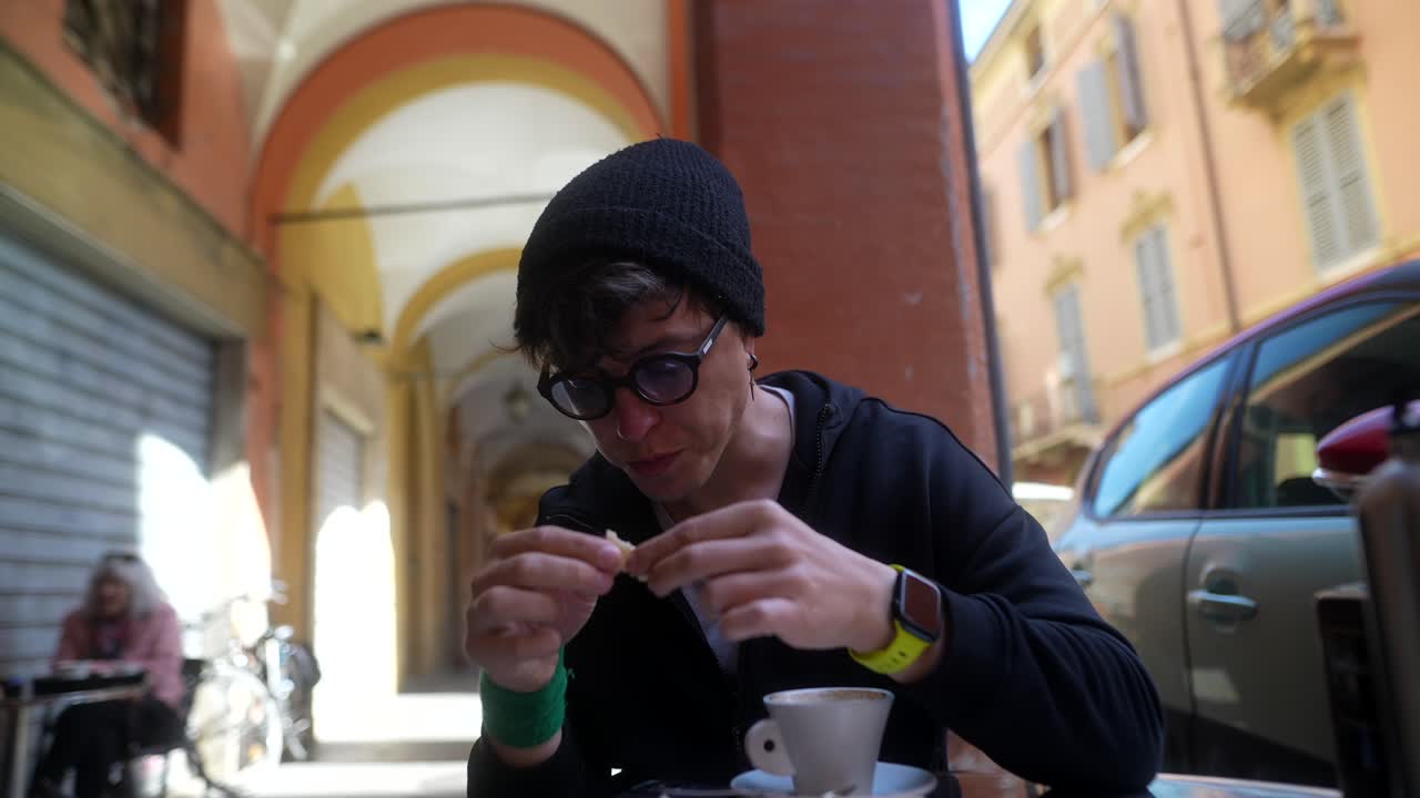 Man eating snack at outdoor cafe in Italy