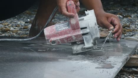 man cutting granite stone