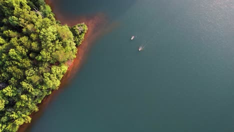 Drone-hovering-still-above-two-people-kayaking-during-sunset