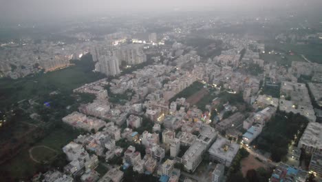 An-aerial-view-of-Bengaluru,-Karnataka's-Electronic-City,-surrounded-by-apartment-buildings,-was-taken-on-a-foggy-morning-in-a-busy-residential-neighborhood