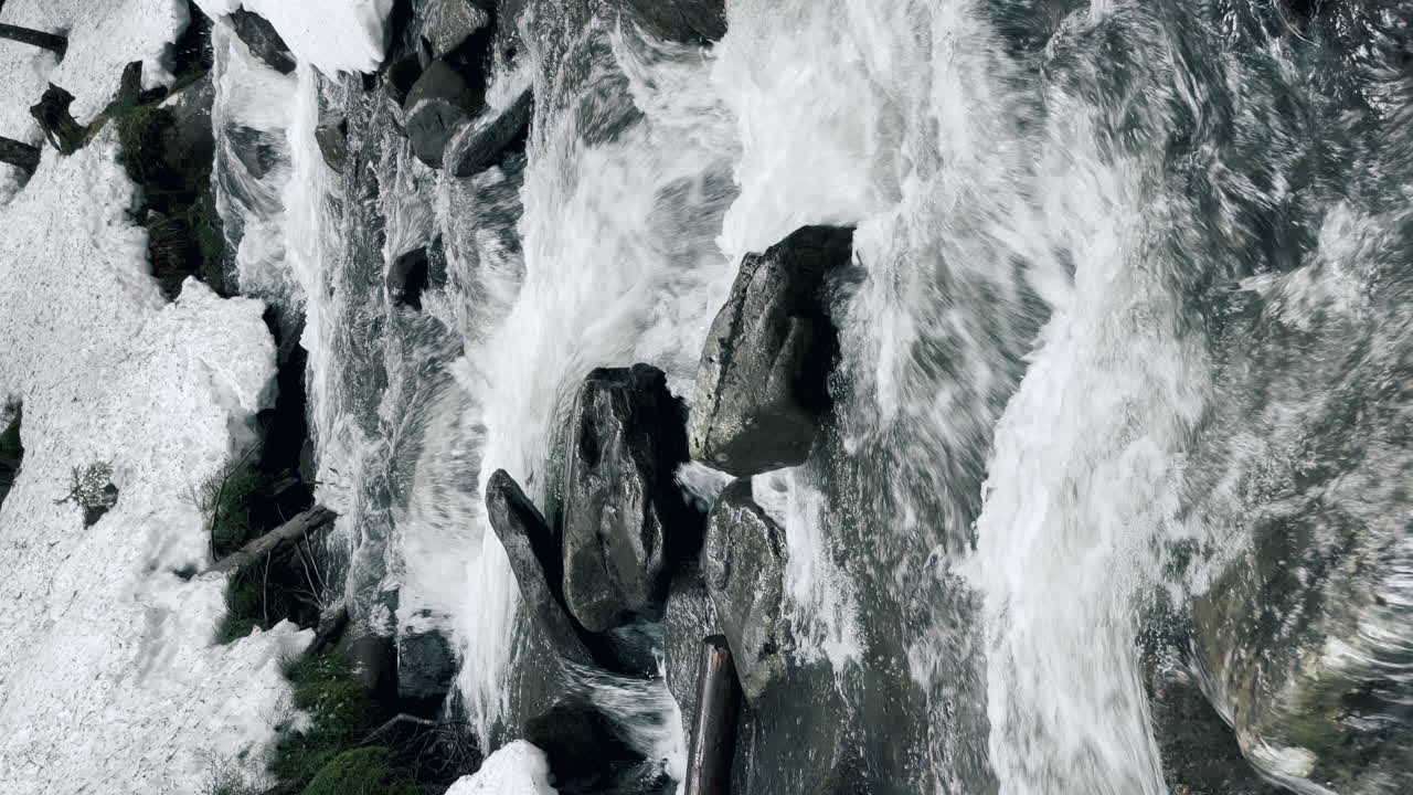 River water in stone landscape vertical view. Mountain creek in winter forest.