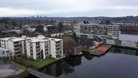 Aerial-view-of-town-at-the-edge-of-the-water-on-an-overcast-day