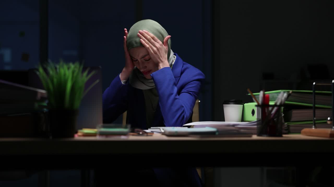 Stressed Businesswoman in Hijab with Headache at Office