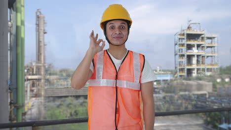 happy indian construction labour showing okay sign