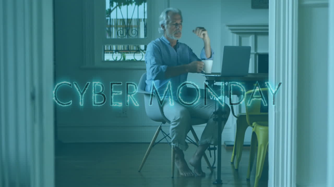 Working on laptop, man sitting at table with Cyber Monday animation
