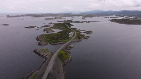 sweeping drone shot of norway’s atlantic ocean road, bridges linking islets