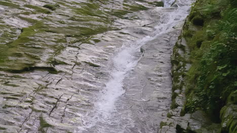 waterfall cascading down mossy rocks