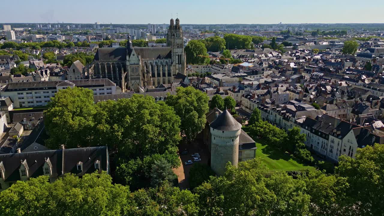 Chateau de Tours and Saint-Gatien Cathedral, gothic architecture and surrounding cityscape on sunny day, France. Aerial drone forward