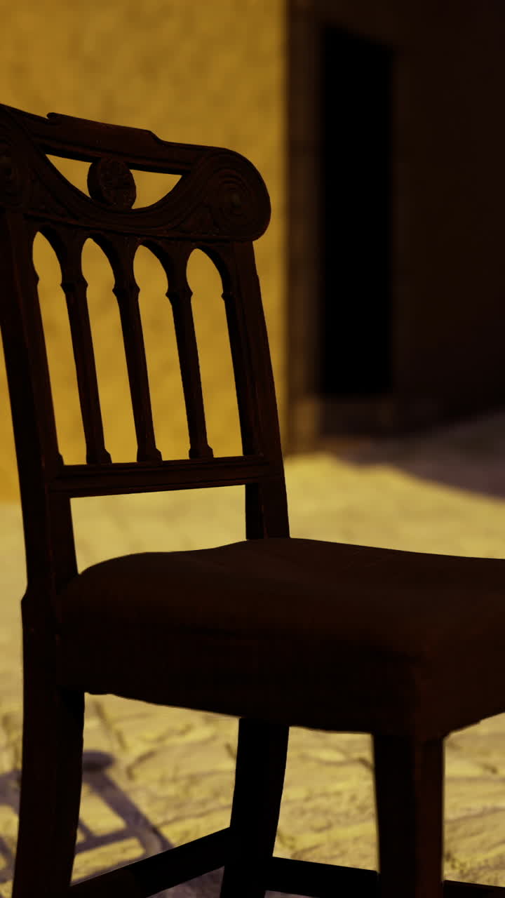 Empty chair in a narrow cobblestone street under soft evening light