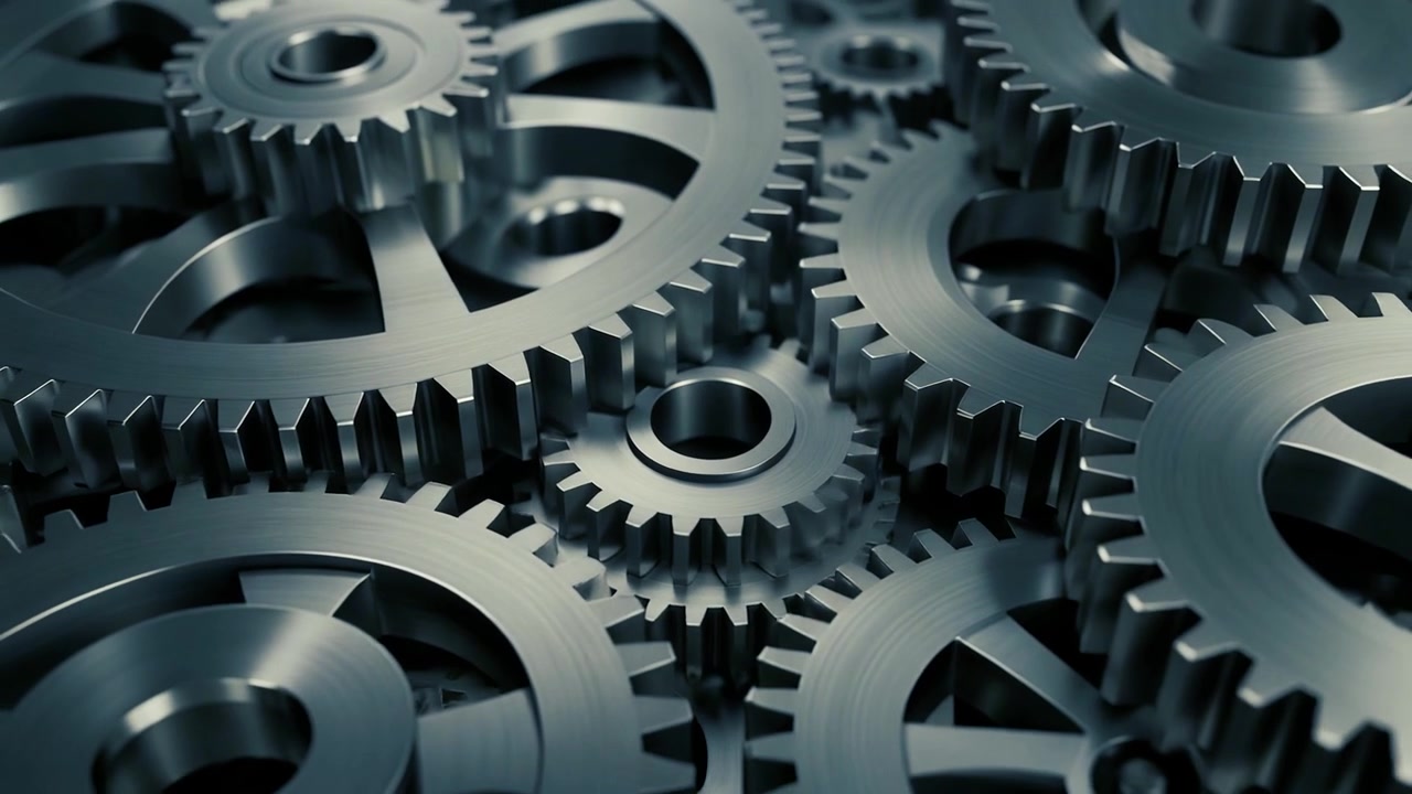 Close-up of Interlocking Metal Gears Rotating in Machinery