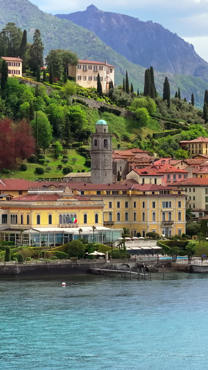 Aerial drone view of the Basilica of St. Giacomo surrounded by houses in Bellagio, Italy. Vertical