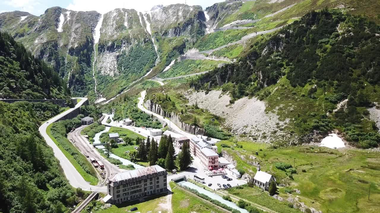 Aerial view of a winding mountain road in the Alps