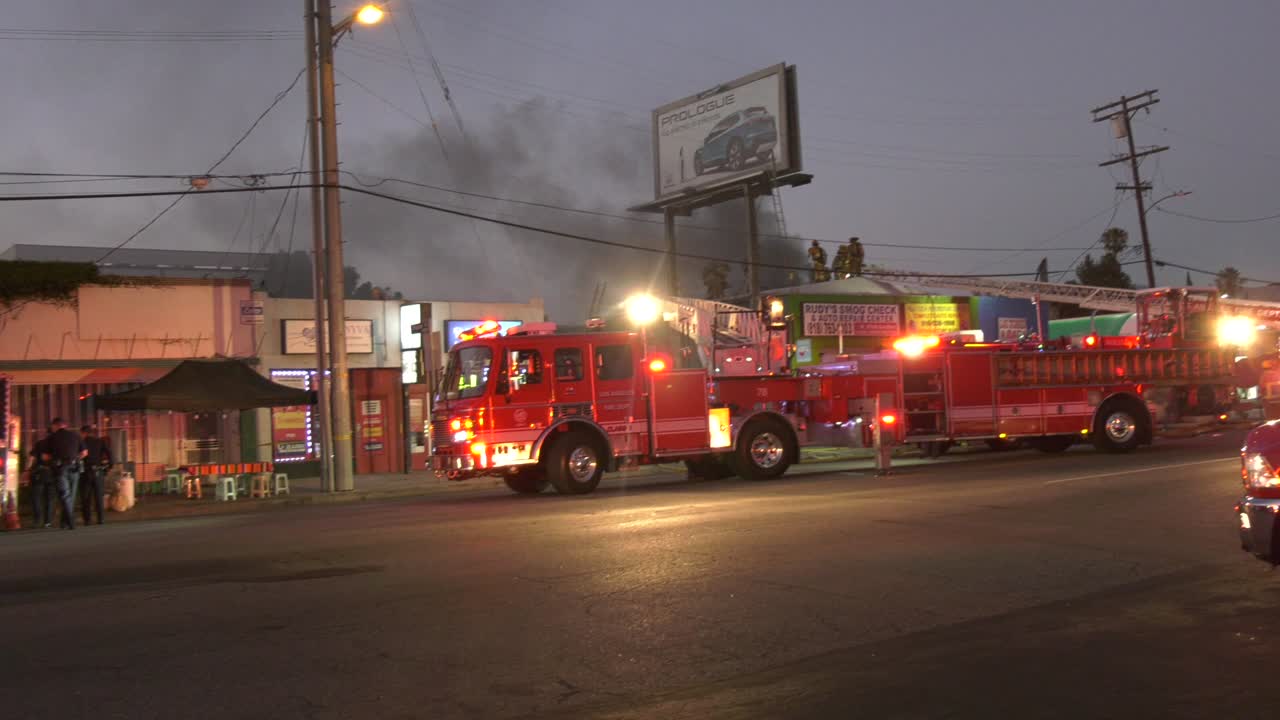 lafd fire truck with ladder amid smoking conditions