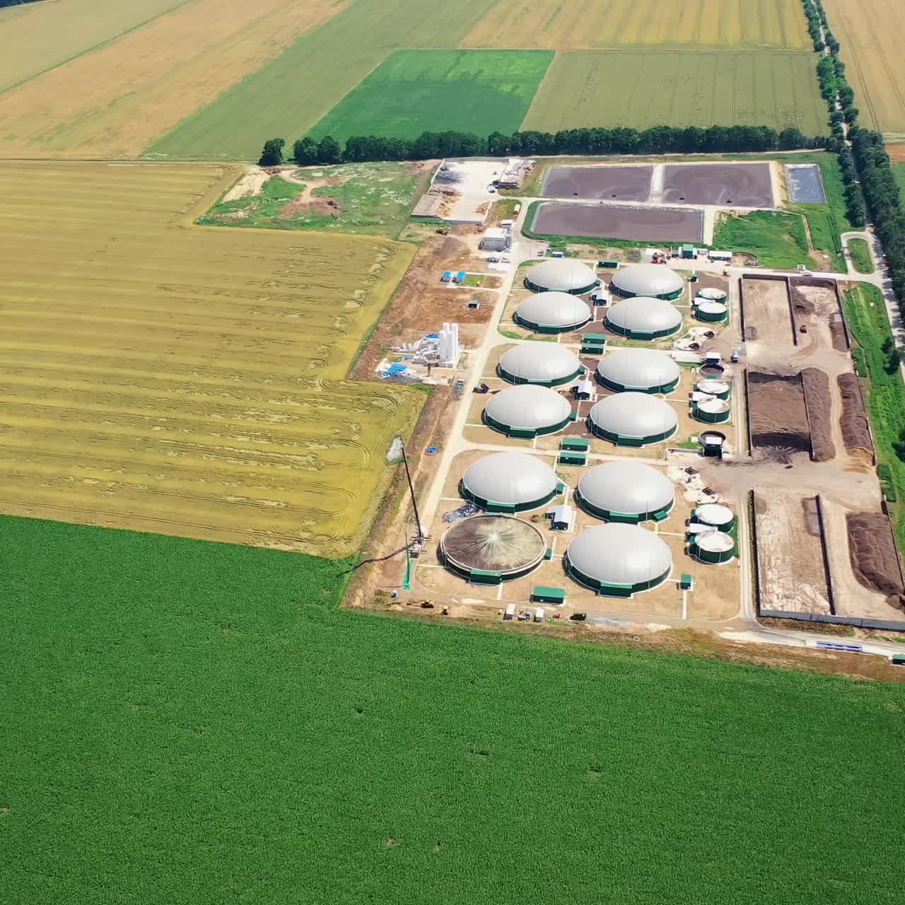Biogas complex in the countryside. Aerial view of generation of bioenergy with biomethane plant