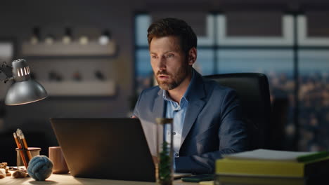 office worker chatting video conference using laptop at night office closeup