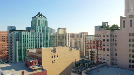 aerial of older apartment buildings and gentrified historic buildings in downtown los angeles includes jesus saves sign and eastern building