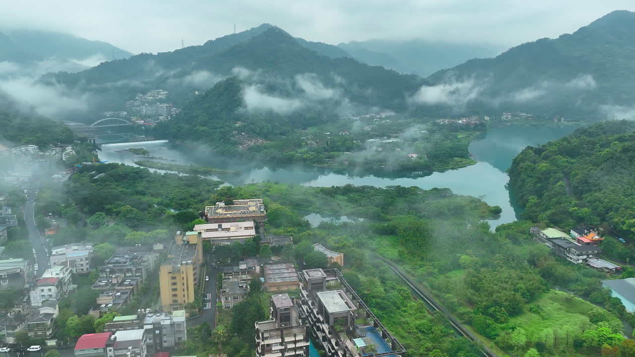 Aerial flight in countryside of Taiwan with fog in the morning with river and mountains