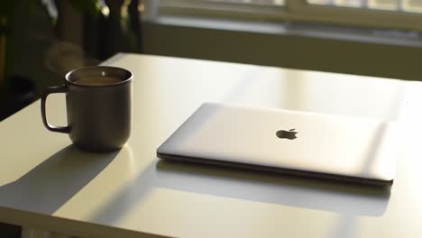 a serene morning workspace with a laptop and coffee mug, exuding calmness and inspiration for productive days ahead