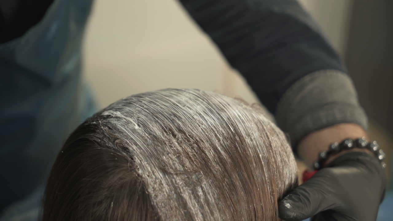 Hairdresser cutting hair of her customer. Hairdresser cutting hair of her customer at the hairdressing salon
