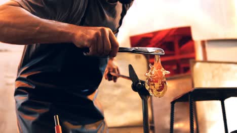 glassblower shaping a molten glass