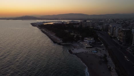 a breathtaking aerial drone shot of the entire floisvos area in athens during sunset