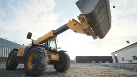 tractor moves rubble to truck. excavator-loader rakes rubble from pile at construction site and loads dump truck. clearing site