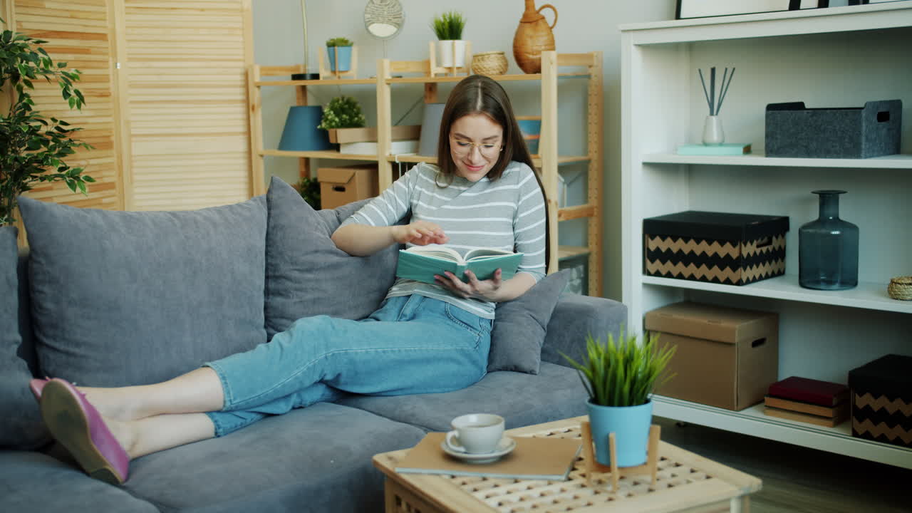 Woman Reading on a Sofa in a Cozy Living Room