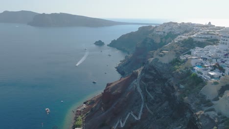 Survey-archaeological-sites-adorned-with-ancient-ruins,-offering-an-aerial-perspective-of-Santorini's-historical-riches