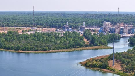 Moving-high-above-large-power-lines-that-span-a-lake-and-go-to-a-power-plant-on-the-other-side