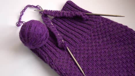 ball of purple wool yarn and knitting needles,  needlework