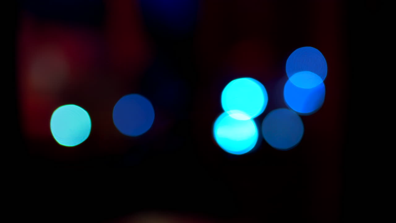 Abstract display of out-of-focus, colourful lights in a dark setting