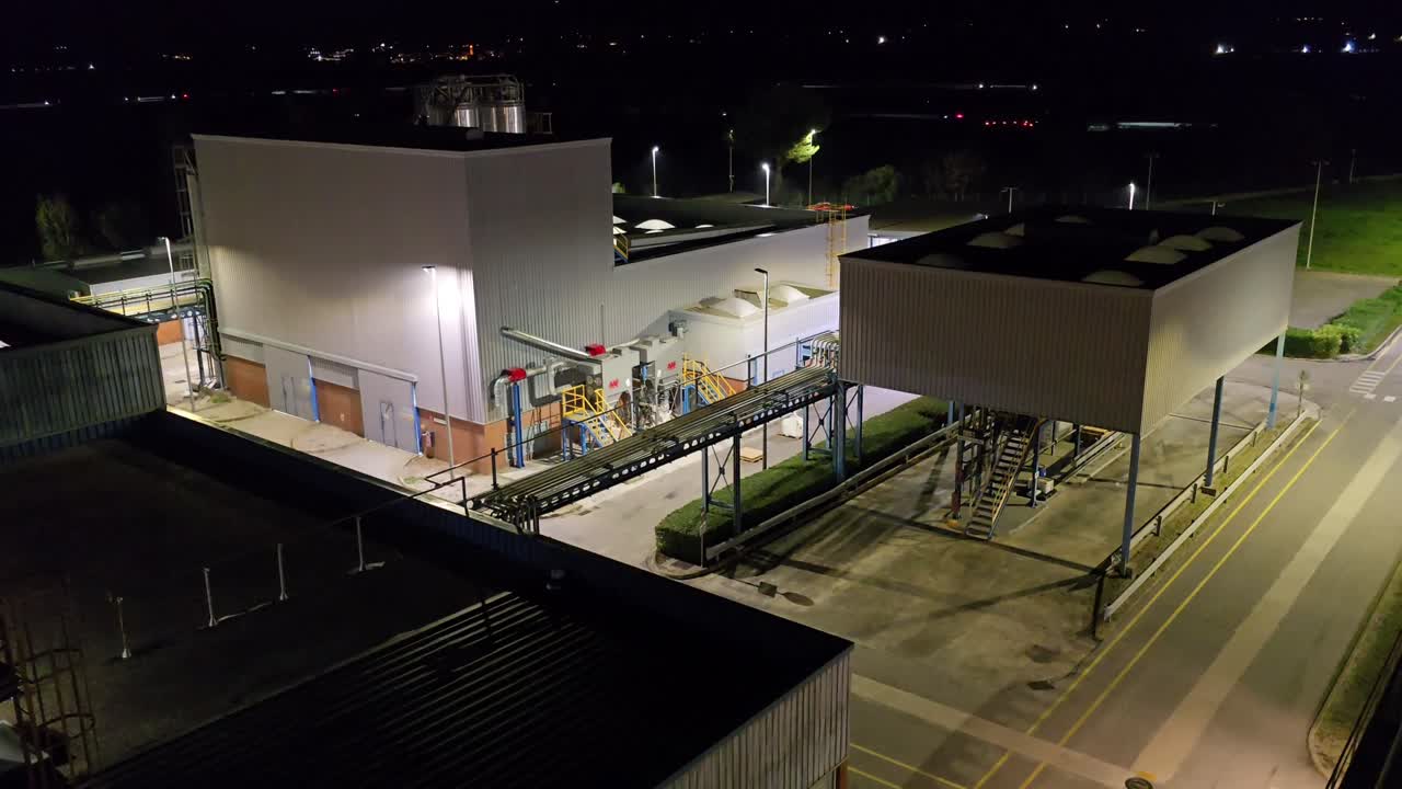 Chemical factory, general plan partial view of the factory, you can see a forklift (bull) working on a dark and starry night.