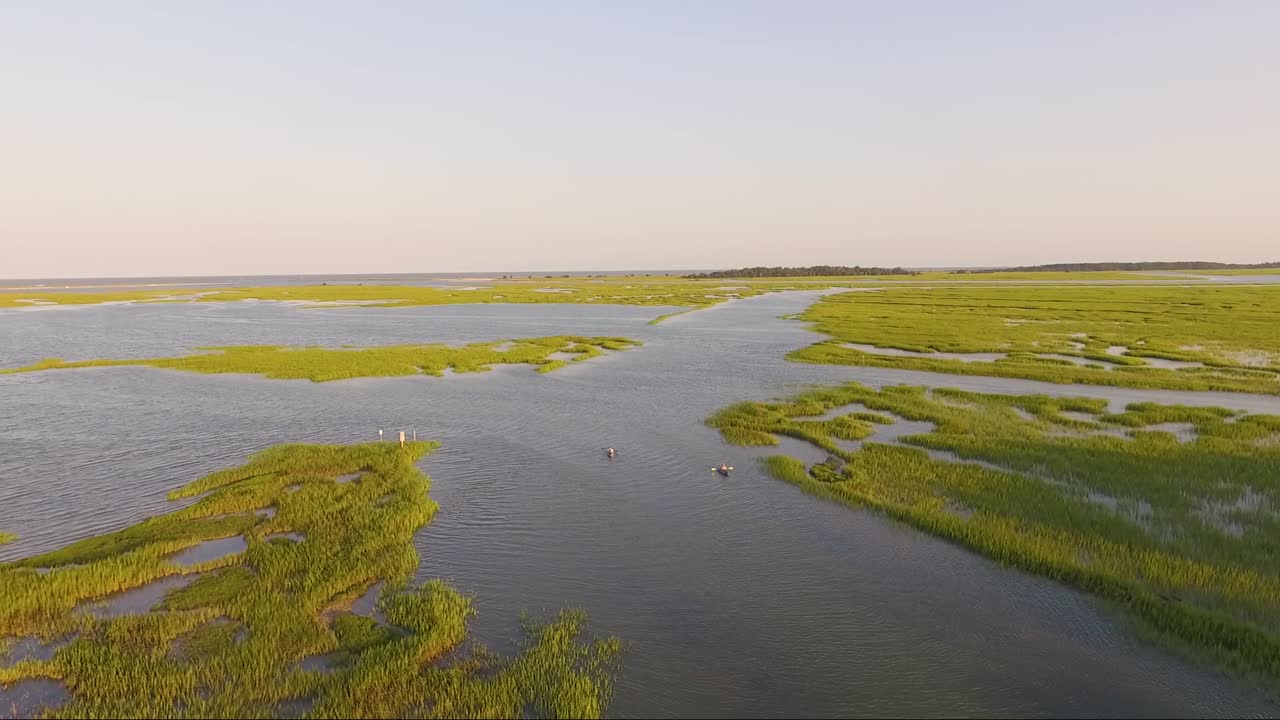 kayakistas en un arroyo al atardecer en murrells inlet sc