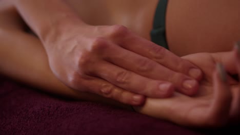 close shot of fingers massaging a girl's arm