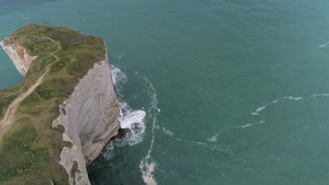 Waves-at-white-cliffs-rock-formation-coastline,-Etretat