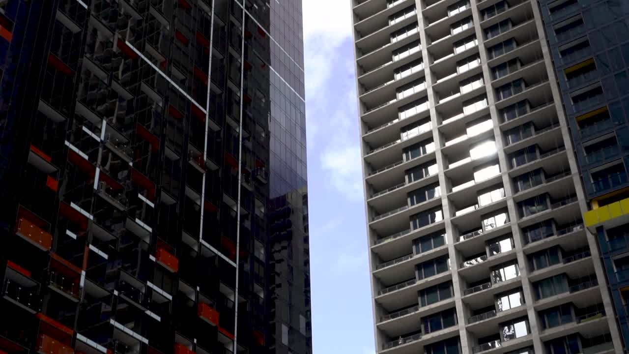 Timelpase of clouds moving between city skyscrapers