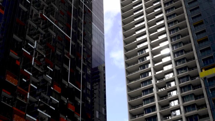 Timelpase of clouds moving between city skyscrapers