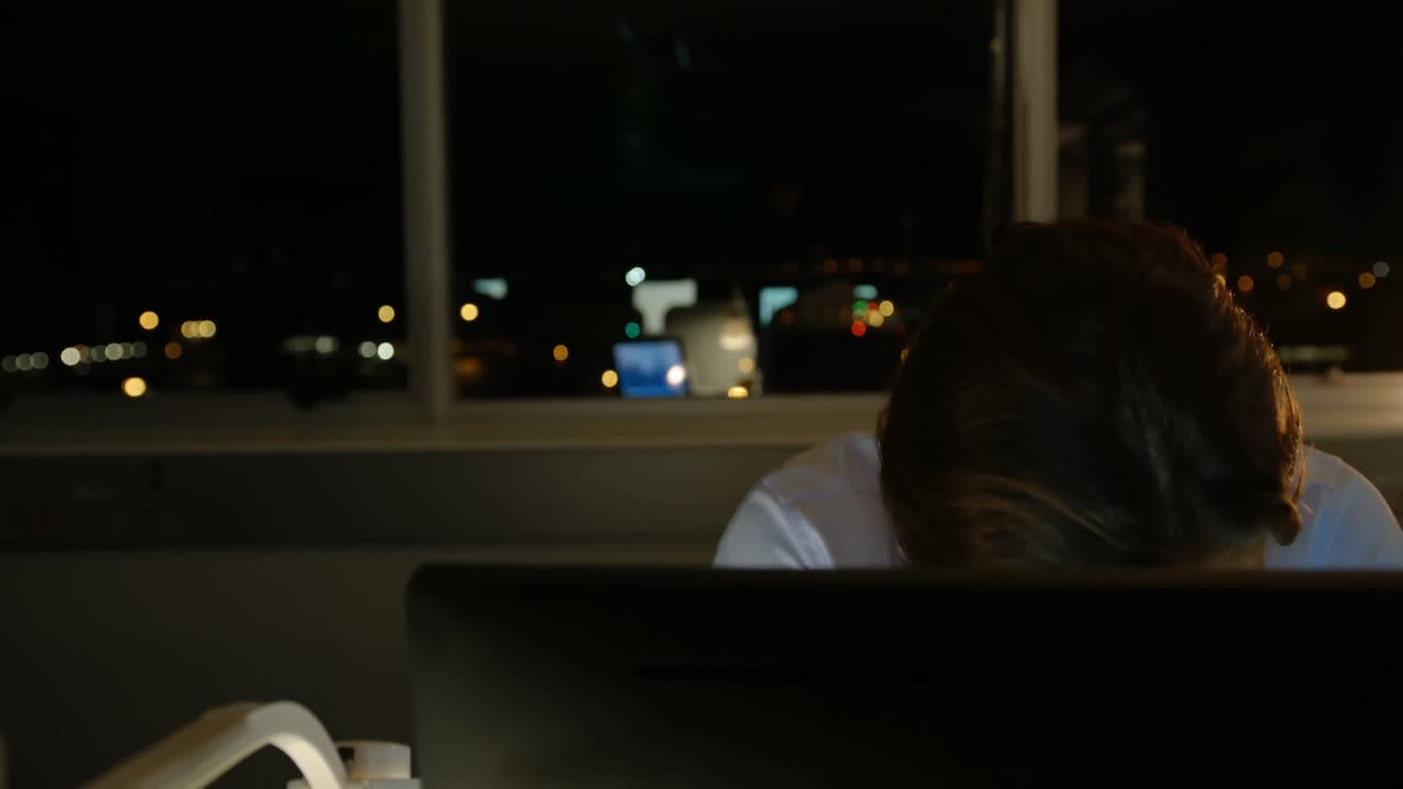 Front view of tired young Caucasian male executive working on computer at desk in modern office 4k