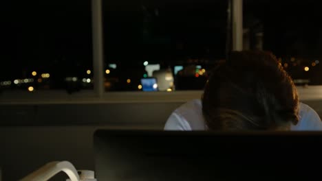 Front-view-of-tired-young-Caucasian-male-executive-working-on-computer-at-desk-in-modern-office-4k