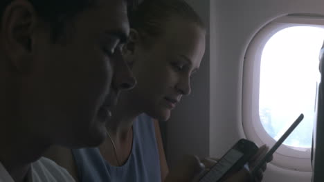 people with gadgets on a plane