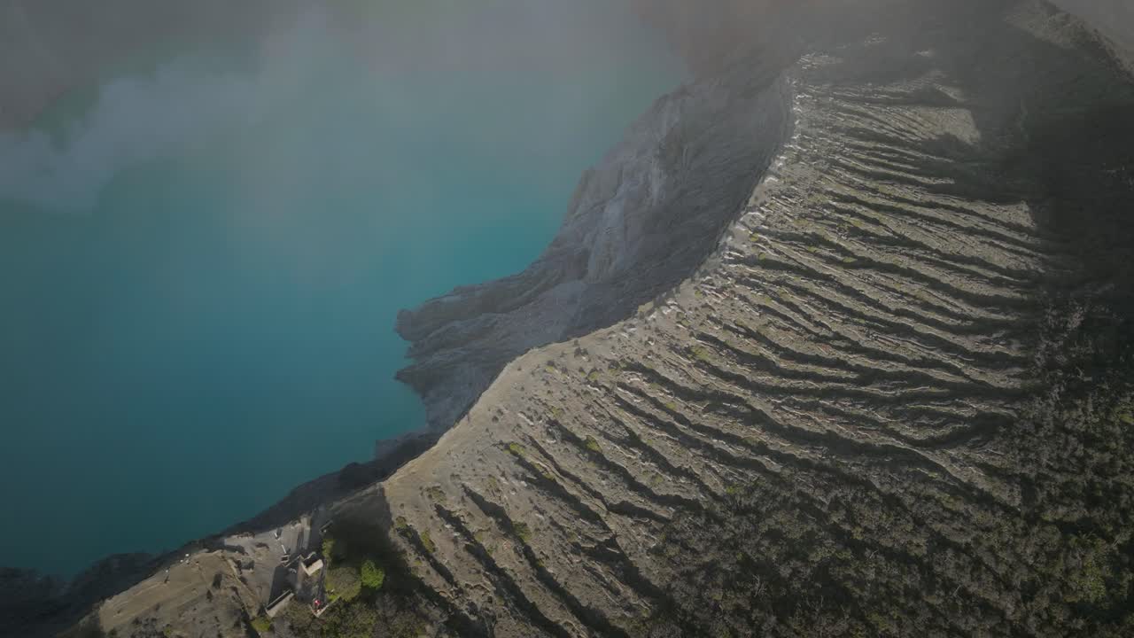 멋진 푸른 산성 호수가 있는 절벽 능선으로 향하는 ijen stratovolcano의 경치 좋은 샷