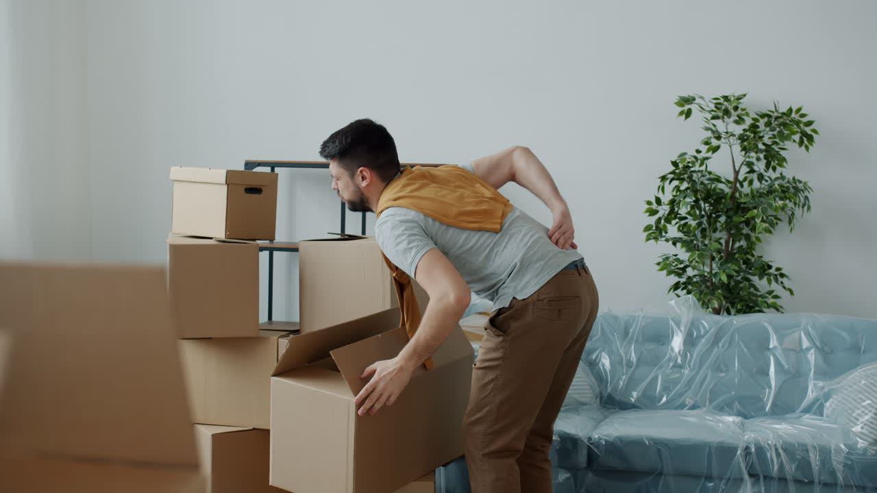 Man Moving, Back Pain, and Packing Boxes