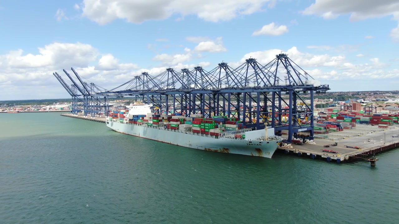 Container moored at Felixstowe loading and unloading Port UK Panning drone aerial