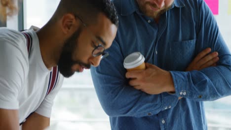 business colleagues discussing over blueprint 4k