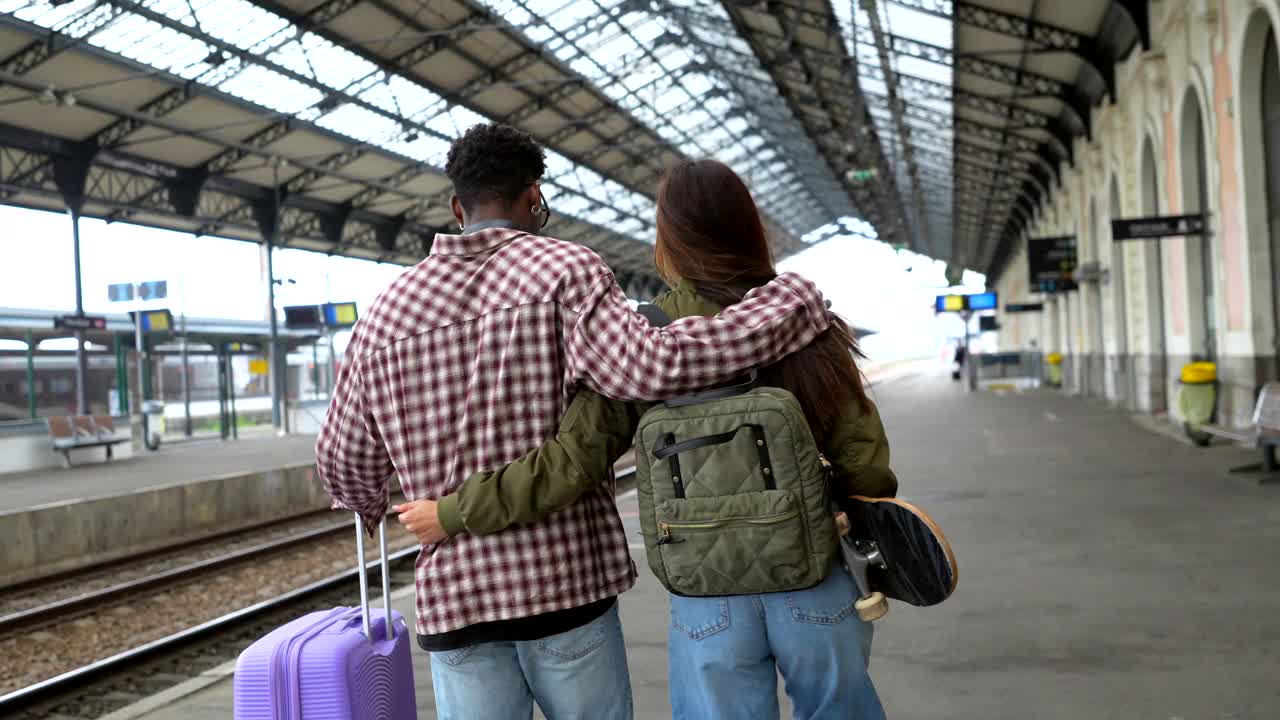 Couple Traveling at a Train Station
