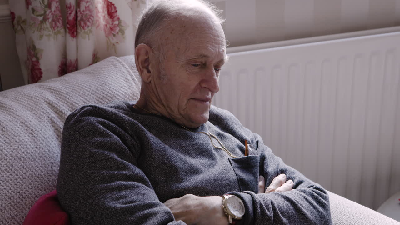 Portrait of an elderly man sitting in a chair