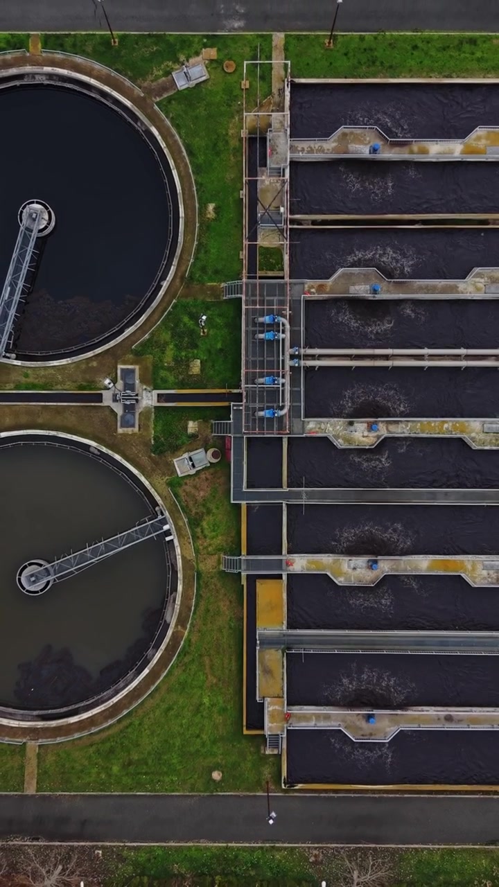 View of a water treatment plant with large tanks and processing areas